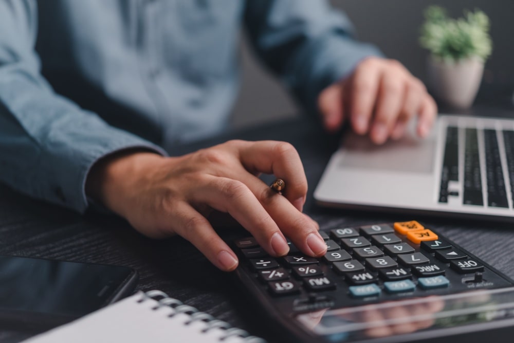 bookkeeper using calculator bookkeeping payroll and budget tax